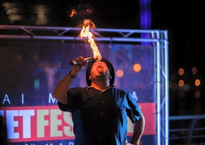 Greg Frisbee eats fire.